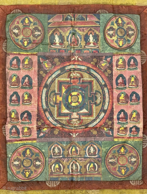 A beautiful antique Tibetan silk painted Buddhist Thangka from 19th century Tibet. At the centre of the colourful design is an elaborate Mandala with Buddha / Lama figures on each corner. The  ...