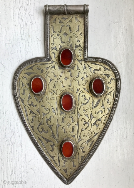 An Excellent  Antique Turkoman / Turkmen silver pendant with gold painted and fired and carnelian inset. These heart shaped pendants (worn in a necklace ) are known as 'Asyk' and this  ...