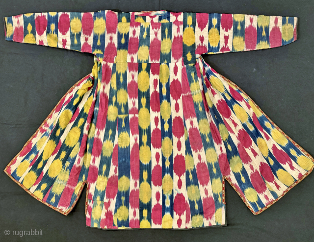 An elegant Antique Uzbek Ikat Robe Chapan  from Bokhara / Bukhara. It is an adras Ikat (silk warp/cotton weft) from early third quarter of the19th Century. The design is relatively unique  ...