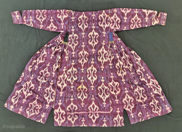A dazzling antique Uzbek silk on silk Atlas / abr Ikat Chapan / Robe dating to the 3rd quarter of the 19th century. It has an archaic design consisting of repeating ornamental  ...