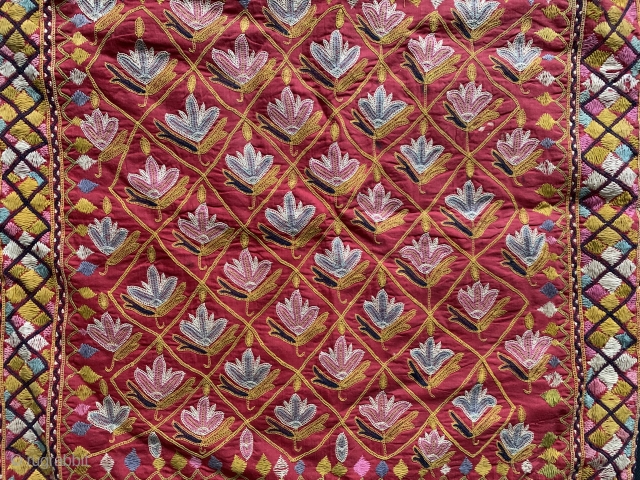 A fine antique Indian silk embroidered hanging from Gujarat (turned into a functional pillow). It dates around 1900  and is a really fine work of textile art. The red field is  ...