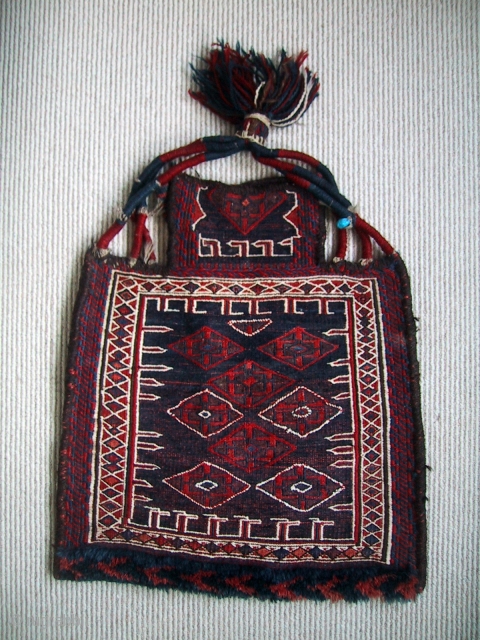 A complete Bakhtiari namakhdan, first half 20th century, with a turquoise amulet woven into the hanging strap. 59 x 50cm, 23" x 20"          