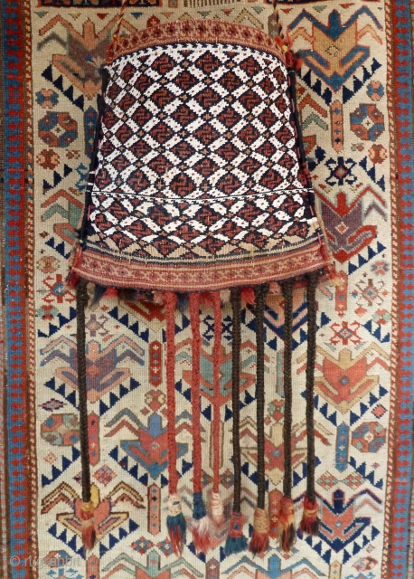 A small Qashqai chanteh with a big presence! About 28cm square, the weft substitution technique with white cotton providing a dramatic contrast. Most of the original tassels are still attached. There is  ...