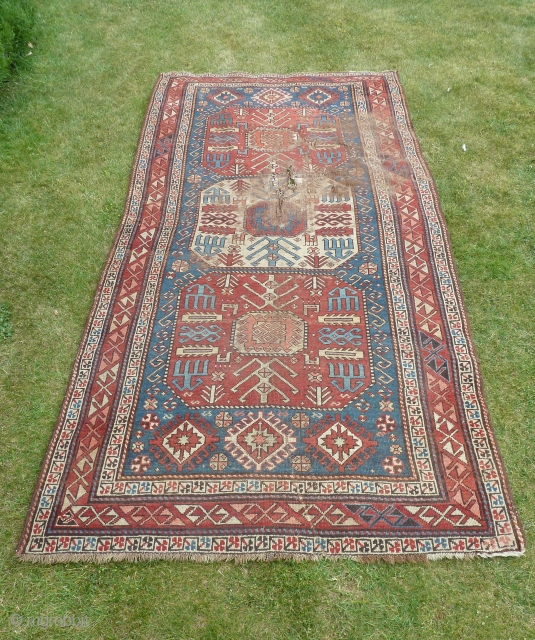 Fresh from an English estate, this Chajli caucasian rug bears the original import marks on the rear. Condition not great in central upper field, needs a clean and some TLC.   