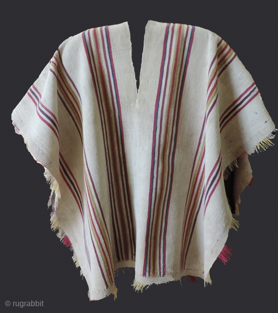 A unique, white ground Aymara Ponchito (small poncho). Altiplano region, Bolivia. Early 19th Century or before. One of a kind cotton and alpaca man's ceremonial overgarment. The only ponchito of the type  ...