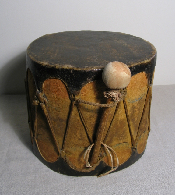 Native American cottonwood drum with original beater. 19th Century, Cochiti Pueblo, New Mexico.  An old, well made example with ceremonial paint remnants still visible. Unlike most old Native American drums this  ...
