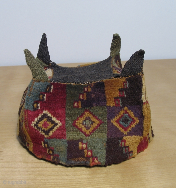 Pre-Columbian four cornered pile hat, Wari culture, AD 500 - AD 800.  Excellent, rare type with subtle, sophisticated colors and very beautiful, fine alpaca fiber.  1st rate collector piece.   ...