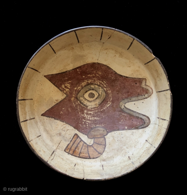 Pre-Columbian shallow bowl with stylized llama head on ivory colored background. Nasca Culture, Peru. a.d. 200 to 600. Size: 10 inches in diameter x 3 inches deep. The Llama is depicted tethered  ...