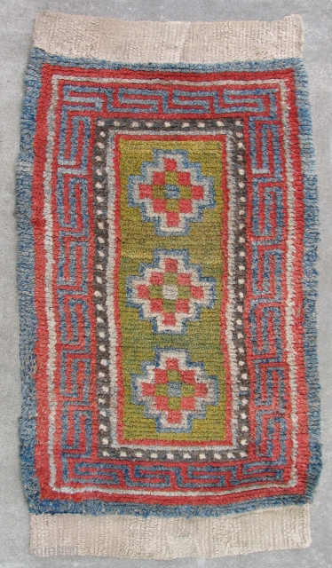 Tibetan three medallion rug. Luminous and lush with a delicate subtle, palette - the rug is old. a so-called Wangden type  with the warp predominant back. The knots were tied over  ...