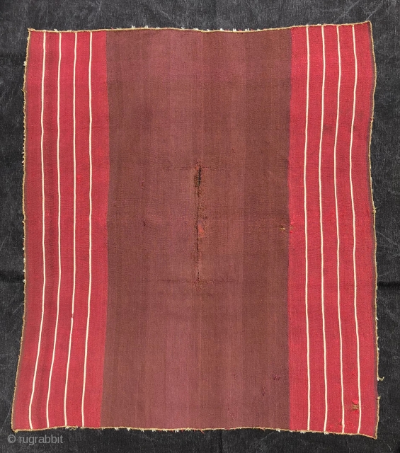 This Aymara warp-faced plain weave (kawa-ponchito) or small poncho with a "vacant center" layout dates to the first quarter of the 19th century. The arrangement of the stripes and the un-patterened center  ...