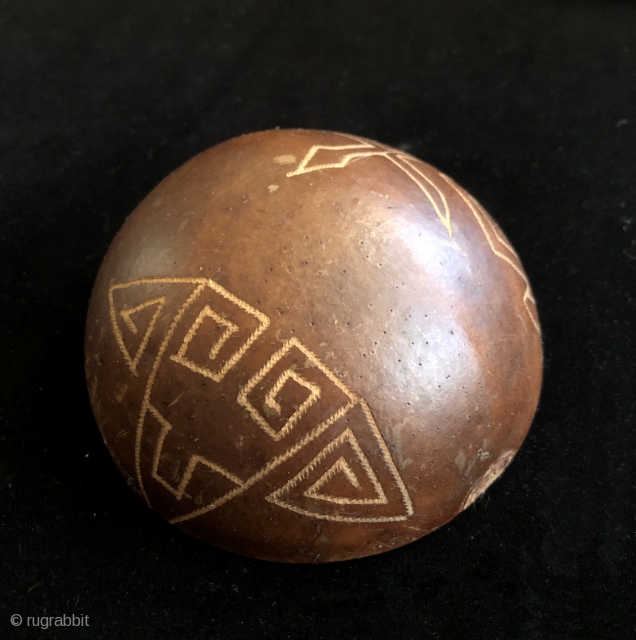 Seven incised gourd bowls. I bought these years ago at a show in New York (I think?) as shaman's cups for the ritual drinking of intoxicants.  I cannot recall anything else  ...