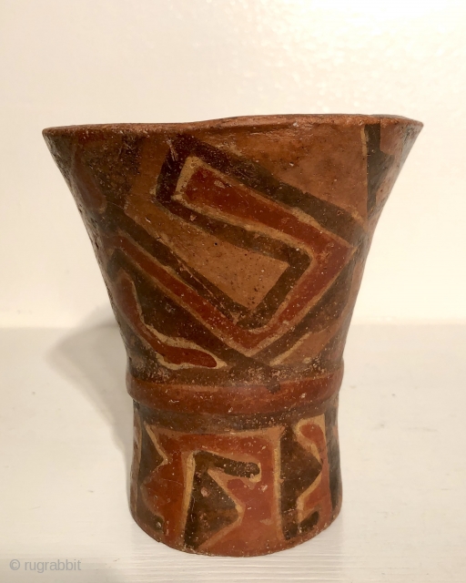 Ancient Andean drinking vessel known as a hero. A.D 800 - 1100.  Ceramic cups in this flared shape were made for the consumption of  alcoholic beverages during ritual occasions.   ...