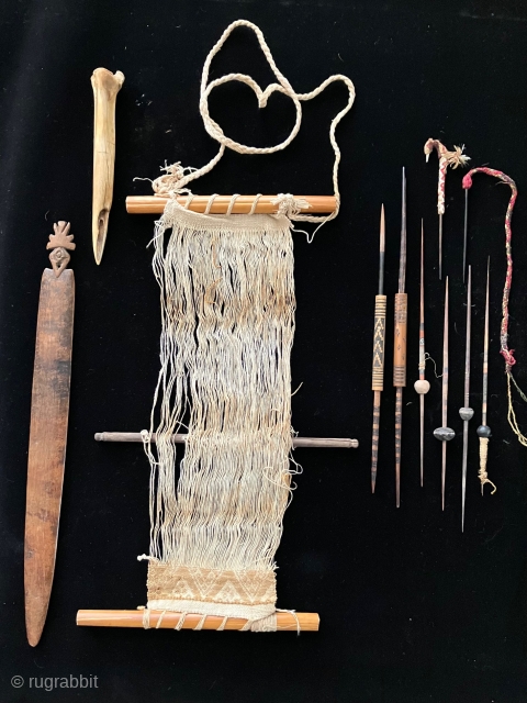 Tools of the trade.  Pre-Columbian weaving tools including a loom with partly completed weaving, spindles, llama bone weft packing implements and weaving swords.  All more than 600 years old.   ...