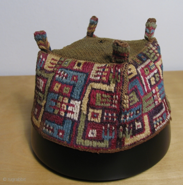 Andean pile headdress.  Wari culture (500 - 800 AD).  This is an excellent "four cornered hat" with interlocked caiman-like depictions. Black Caiman are the largest predators in South America. They  ...