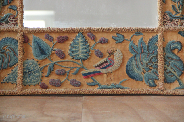 17th/18th century English Crewelwork recycled into a mirror frame in the early part of the 20th century. Makes a great fun object! 2'8" x 2'10" / 82 x 87cm.    