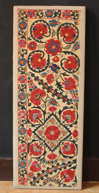 Mid 19th century Nurata Suzani fragment, professionally mounted.
1'3" x 3'4" / 38 x 101cm                   