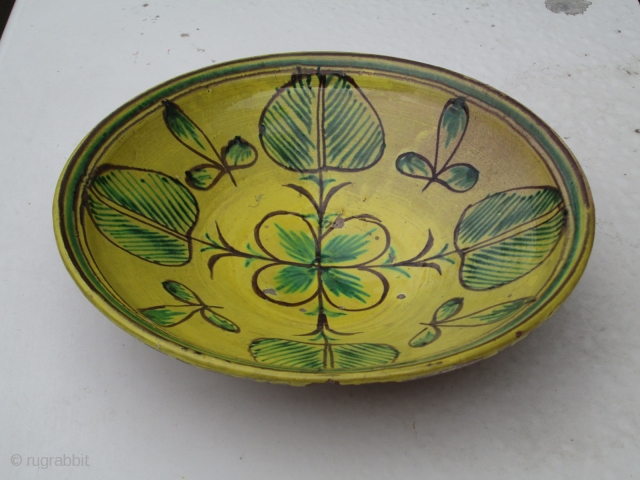 Spanish or Italian 19th.century red earthenware ceramic shallow bowl, glazed upper surface with quartered clover-leaf pattern in yellow, green and brown, has a very resonant ring when tapped suggesting fired at a  ...