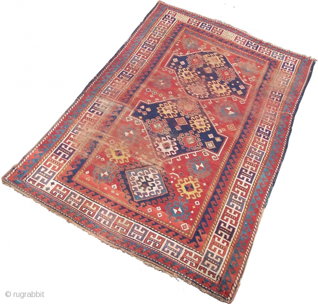 Kazak rug, Caucasian- beautiful old triple medallion rug with red field and guards giving a classic 'floating effect' with the delicate balance between motifs and red ground; this effect is compounded by  ...