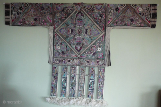 "Hunderd-bird" Coat of Miao minority, Rongshui style. Quizhou, south China

Collarless jacket with sleeves and a"skirt" of twelf free-hanging panels. The jacket is supposed to be part of a shaman's costume. It was  ...