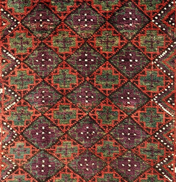 Antique Baluch balisht. Unusual palette, striking aubergine against a jade green and rust madder red. Fragmented ends and dense shimmering pile. A familiar design rendered with unusual minimalism and a distinctive array  ...