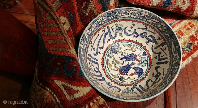 Old Turkish (Iznik?) bowl with calligraphic inscription.  Diameter 8.25 inches, 3.75 inches tall.  A crack and minor nick with old repair. Intact and stable,  Shows beautifully though fragile.   ...