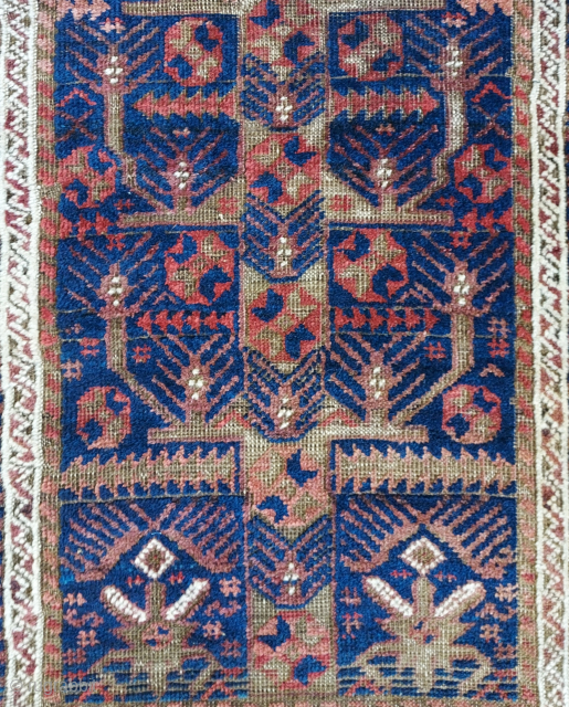 Antique Baluch rug with Rare Tree and stylized garden design on Deep Indigo ground, 34 x 64 inches. Lush pile with uneven wear and corroded browns; rough passages at sides stabilized by  ...