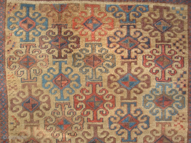 Symmetrically knotted Baluch with 43 Hooked motifs on Camel Field. 40 x 63 inches (102 x 170 cm) without kilim ends. Good condition, original goat hair side finish, end kilims rough. This  ...