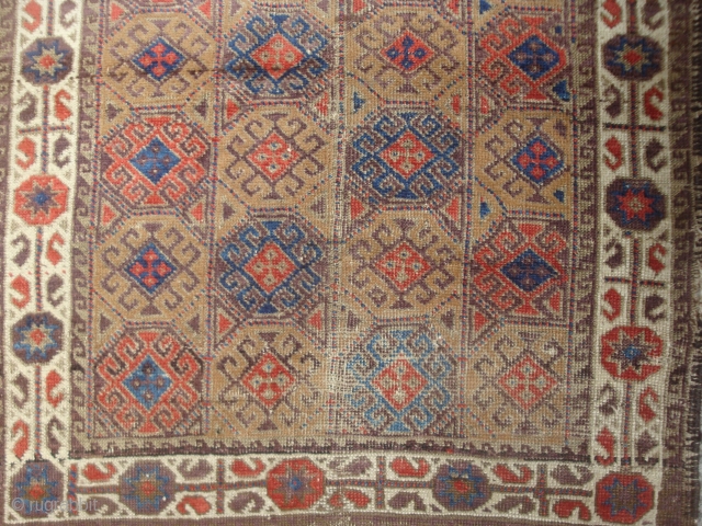 detail of colorful Antique Symmetrically knotted small Baluch rug with 40 Guls in rectangle lattice.                  