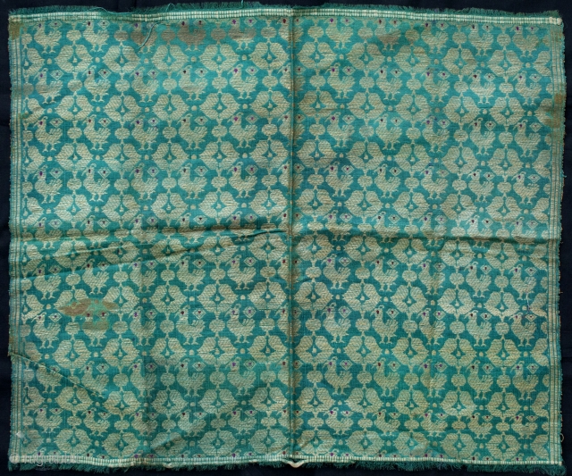 A golden zari brocade fragment depicting a bird's motif from benaras,India
Period: Late 19th/Early 20th C.

Size: 56 X 46 cms              