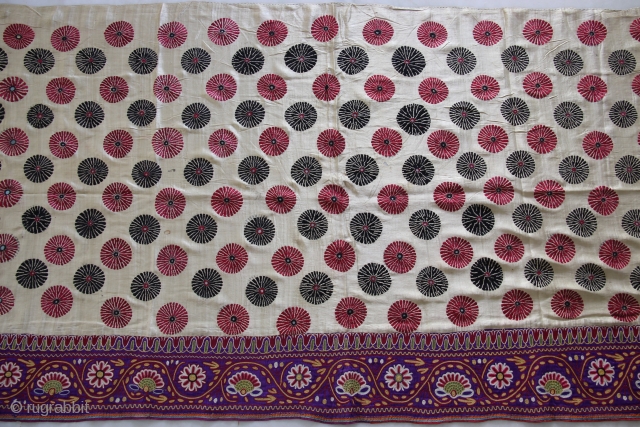 A full-sized embroidered cloth for a Chaniya (Skirt) from Kutch, Gujarat. The cloth is decorated with round flowers and the border with a colourful floral pattern all through the length of the  ...