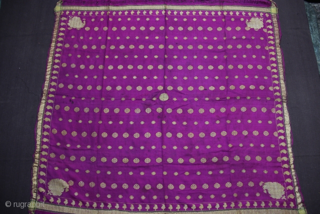A square gilt brocaded Silk textile, possibly a Rumaal (cover for the presentation plate).  Also possibly a Chandarvo (to hand on the ceiling during auspicious occasions Weddings, etc.). Probably Gujarat.  