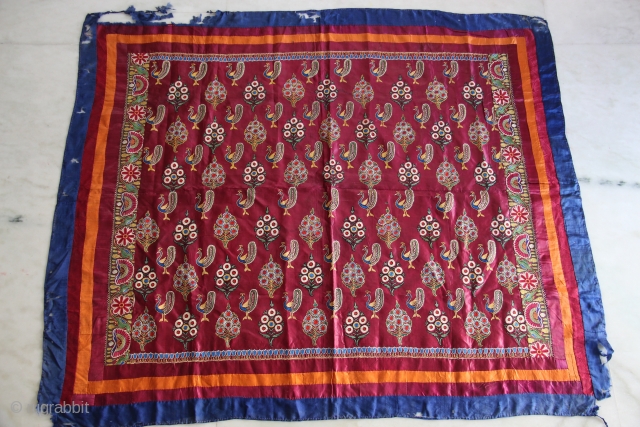 A lovely Mochi embroidery textile in maroon satin silk decorated in chain-stitch with peacock and floral motifs.                