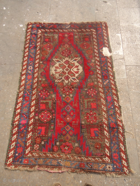 Karabagh Rug Fragment with inscription and date,not ofr the condition conscious,good design colors and age.Size 5'5"*3'5".e.mail for more info and pics.            