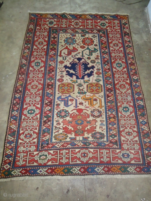 Lovely Ivory ground Shirvan with Kufic border,beautiful colours and desigen.Size 6*4ft.E.mail for more info.                   