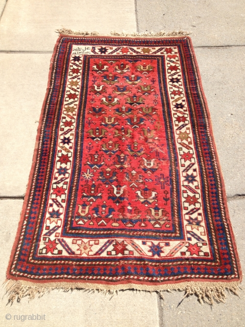 Nice little Kazak with inscriptions in the top left corner, good condition. Please ask if you require more pictures. Size:3-10 x 4-8.           