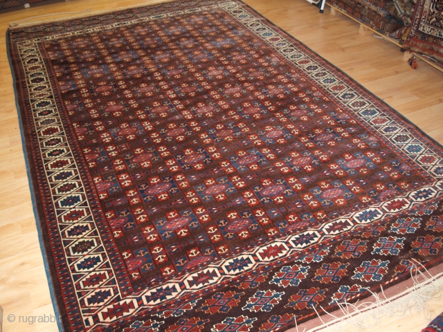 ANTIQUE YOMUT TURKMEN MAIN CARPET WITH KEPSE GUL DESIGN, CIRCA 1900.

Size: 10ft 8in x 6ft 8in (324 x 203cm).

The carpet has a rich brown ground colour with some very nice blues and  ...