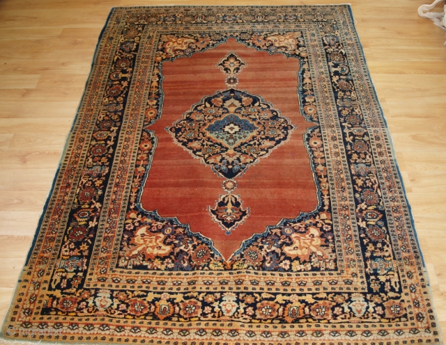 Antique Persian Tabriz rug of classic design with a central medallion on a very soft abrashed terracotta ground.

Size: 6ft 0in x 4ft 3in (183 x 129cm).

Circa 1900.

The rug has a change of  ...