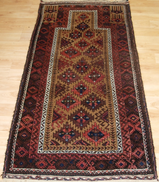 Antique Baluch camel ground prayer rug with interesting Turkmen inspired design. 

Circa 1900.
Size: 5ft 3in x 2ft 8in (160 x 82cm).
The rug is beautifully drawn and has excellent colour, the camel wool  ...