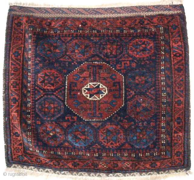 Antique Baluch saddle bag face with 'star in octagon' design of scarce small size.

Circa 1880.

Size: 2ft 2in x 1ft 11in (66 x 59cm). 

The saddle bag is of well known 'star and  ...