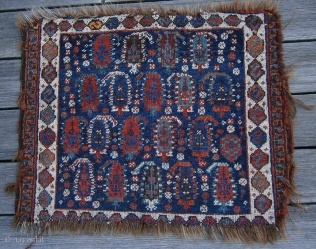 {87} Afshar bag face, 57 X 45 cm, with 19 Boteh (4/5/5/5) and dragon main border. Some lost pile at either end and damaged selvages, but field intact. Great dyes.
-Kolya   