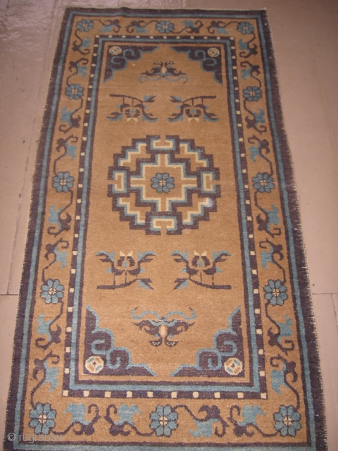 This chinese rug probably dates 1900-1920. The darker purple-blue is slightly corroded in the corners otherwise the rug is in generally good pile. It measures 3' x 5'9".     