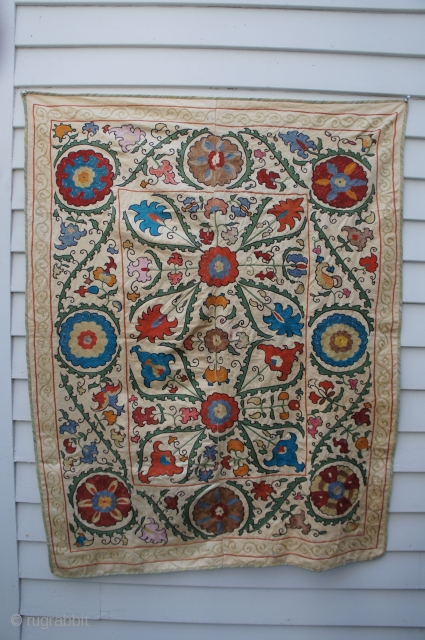 Small Suzani, Turkmenistan. 37" x 47 1/2". Probably 20th C. but I am not sure of the age. Machine stitched edge. No bad colors. A few small stains near center. No rips,  ...