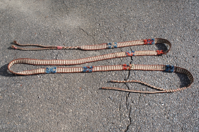 Likely late 19th or early 20th C. packing strap. Possibly Balouch. Approximately 206" by 1 3/4" wide. All wool with two red dyed cloth wraps, panels of tufted colors including aubergine and  ...