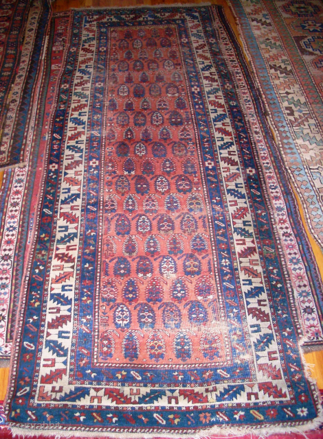 Antique Caucasian with boteh design (possibly Kurdish) 3'8" x 10'5" with one bite out of the side and wear commensurate with age.