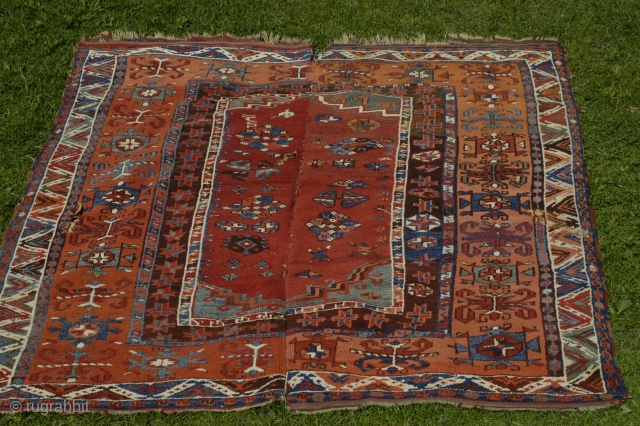 Old dated Konya area rug, 1250/1834 or 1256/1840, woven in two halfes, 167x150, holes,a few old restauration and corrosion in some of the brown areas.
Metal tread high lights in the dated half. 