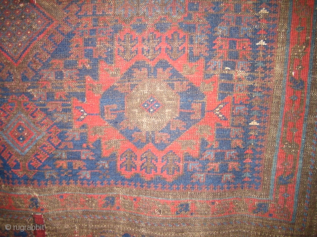 Very old Baluch main carpet, hard wear, some holes fixed with parts from old kelims, pile rugs and weft float textiles.
The red colour is very good, a lot of different blue hues  ...