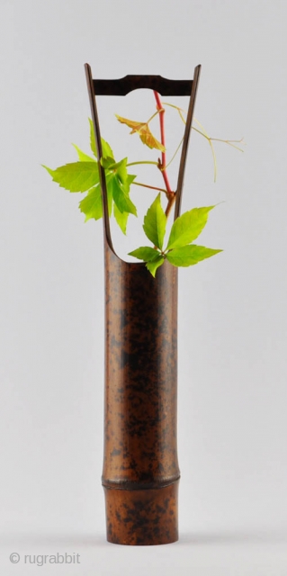 An elegant simple Japanese flower vase (hanaire) of dark bamboo with a natural design of black spots and an attractive patina. Unsigned.Probably first half of 20th century. 32x5 cm.    