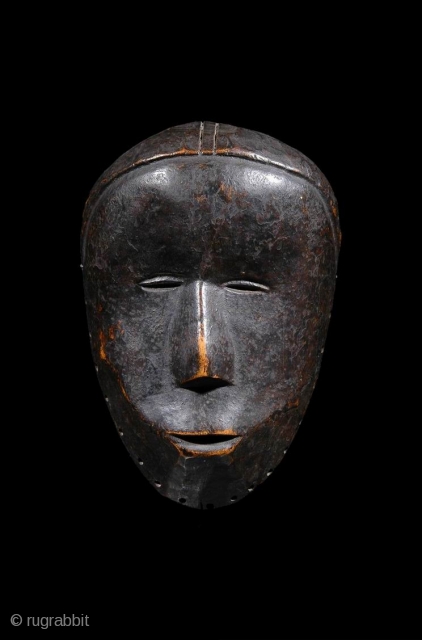 cod. 427
Old and intricate expression for this heavy Ma Go house mask dark and uncrested patina
In this case, however, the mask is pierced around the rim and may well have been attached  ...