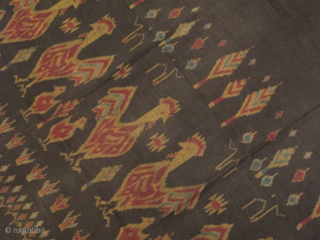 A weft ikat silk tube skirt from Northeastern part of Thailand. A lovely motif of roosters and chicks in repeating fashion on dark grey background. Est age 40-60 years. Wearable condition.   ...