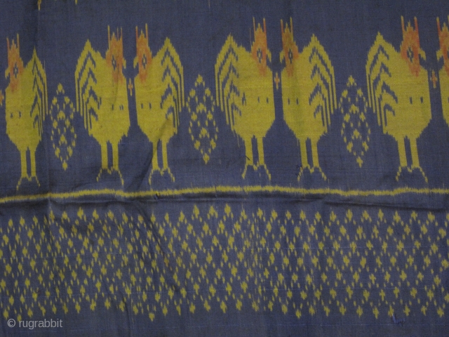 A weft ikat silk tube skirt from Northeastern Thailand with lovely repeating series of double facing chickens on the lower half while the upper part adorned with series of graphical bouquet motif.All  ...